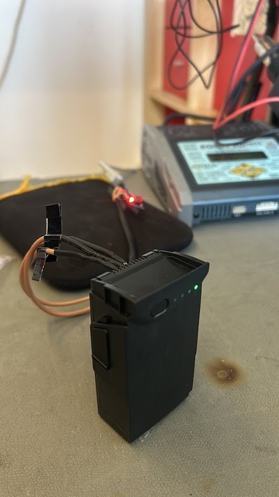Hyperion charger with alligator clips on BMS board during Mavic Air unlock